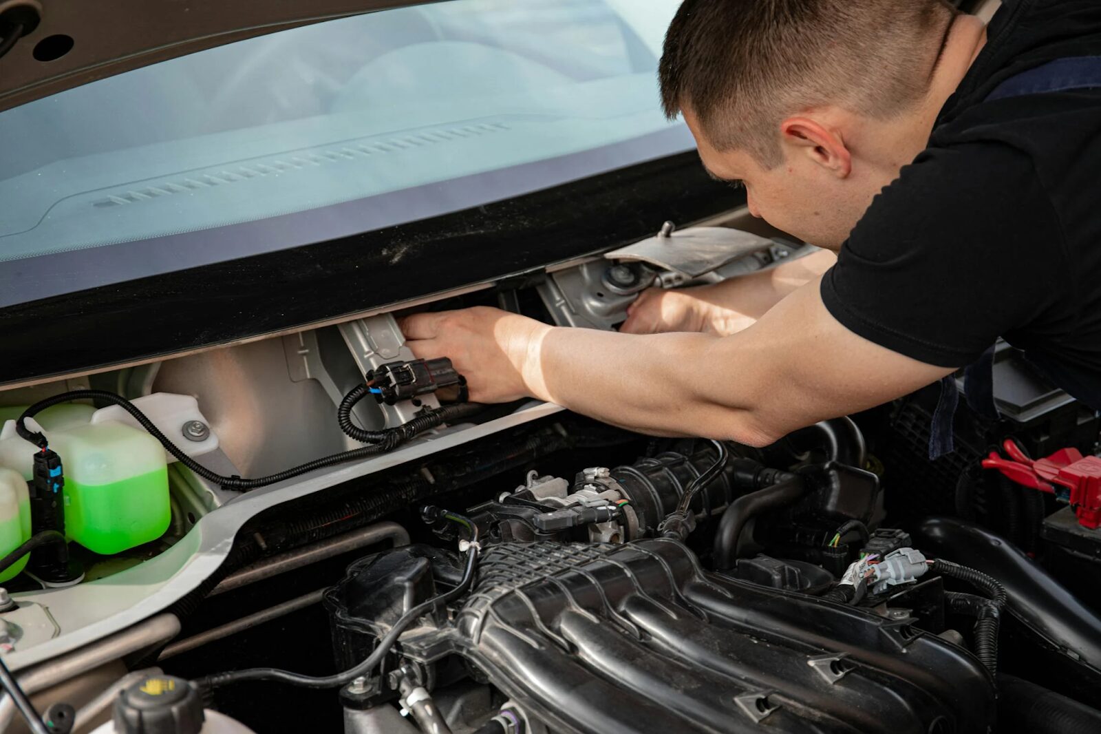 Close-up of a mechanic fixing an engine of a car