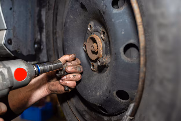 car-mechanic-bolts-steel-car-wheel-with-pneumatic-wrench-car-workshop-visible-hands